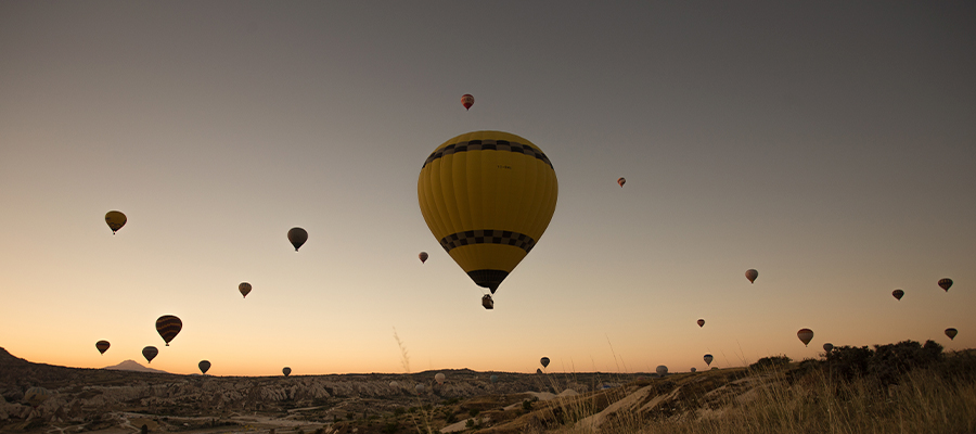 Beautiful view of hot balloons in the sky during sunset in Cappadocia, Turkey